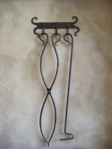 Hammered back plate with 3 hooks holds a pair of tongs and a fire poker