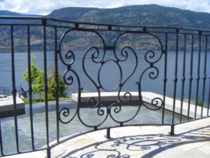 A curved railing panel filled with an oval and curls