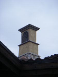 An arched metal grate attached to a tall house pillar