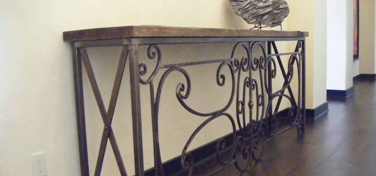 Forged and fabricated 9 foot long hall table. Hammered curls throughout the center and a wooden top.