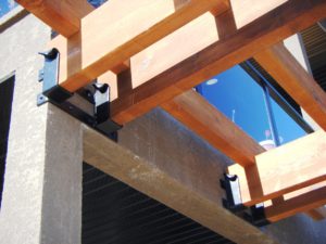Double timber frame brackets with a forged curl at the top