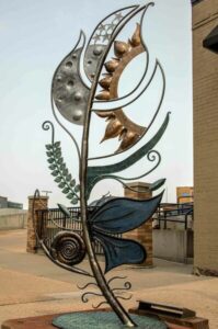 A seven foot tall feather sculpture made of steel