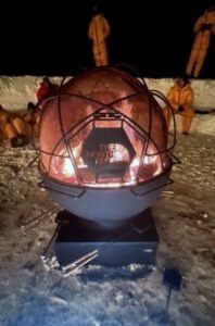 Custom made square base and a 36" fire bowl with handles. Then a geometric spark dome on top with a hinged door and The North Face logo.